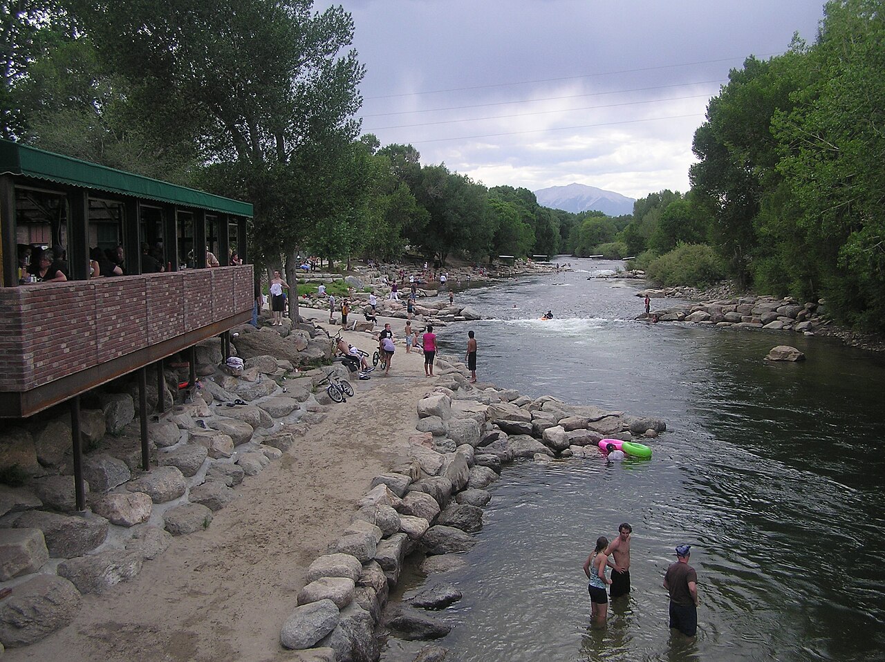 Arkansas River running through Salida, Colorado, with wooded banks and mountains beyond